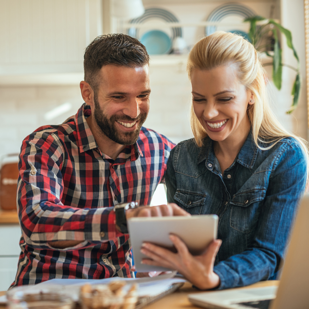 man and woman together on ipad