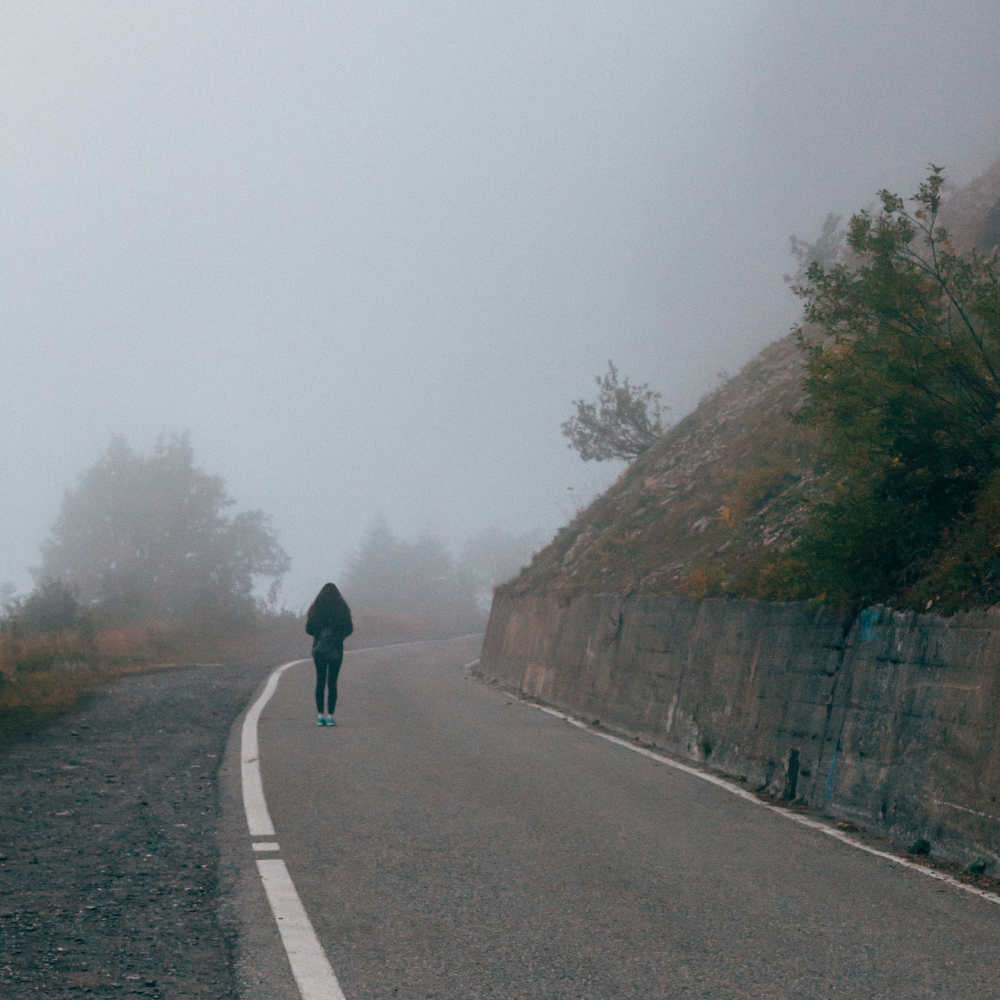 woman walking alone down the road