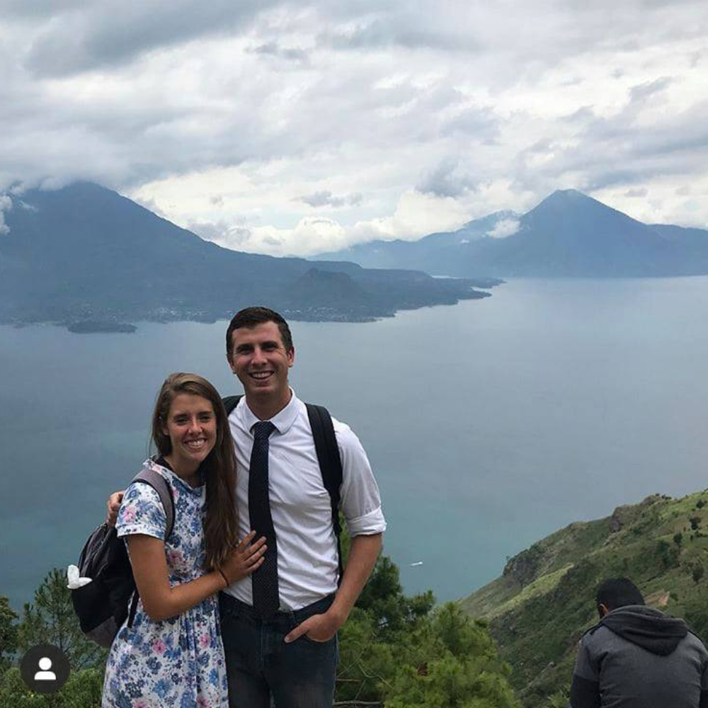 man and woman in front of lake